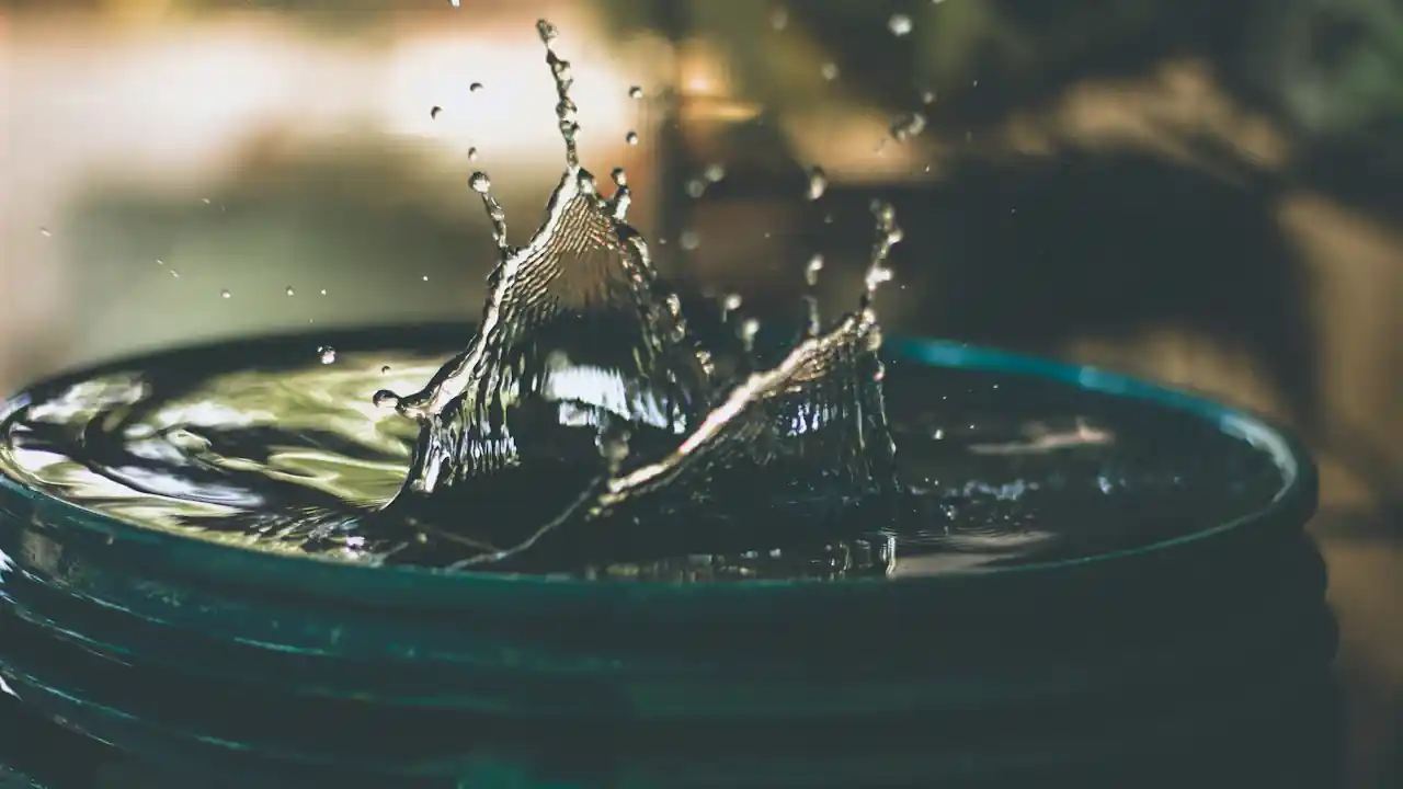 Water heater flushing in La Mirada: water splashing into a bucket