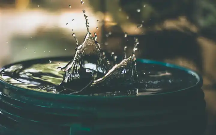 Water heater flushing in La Mirada: water splashing into a bucket